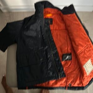 2T quilted jacket with orange lining.